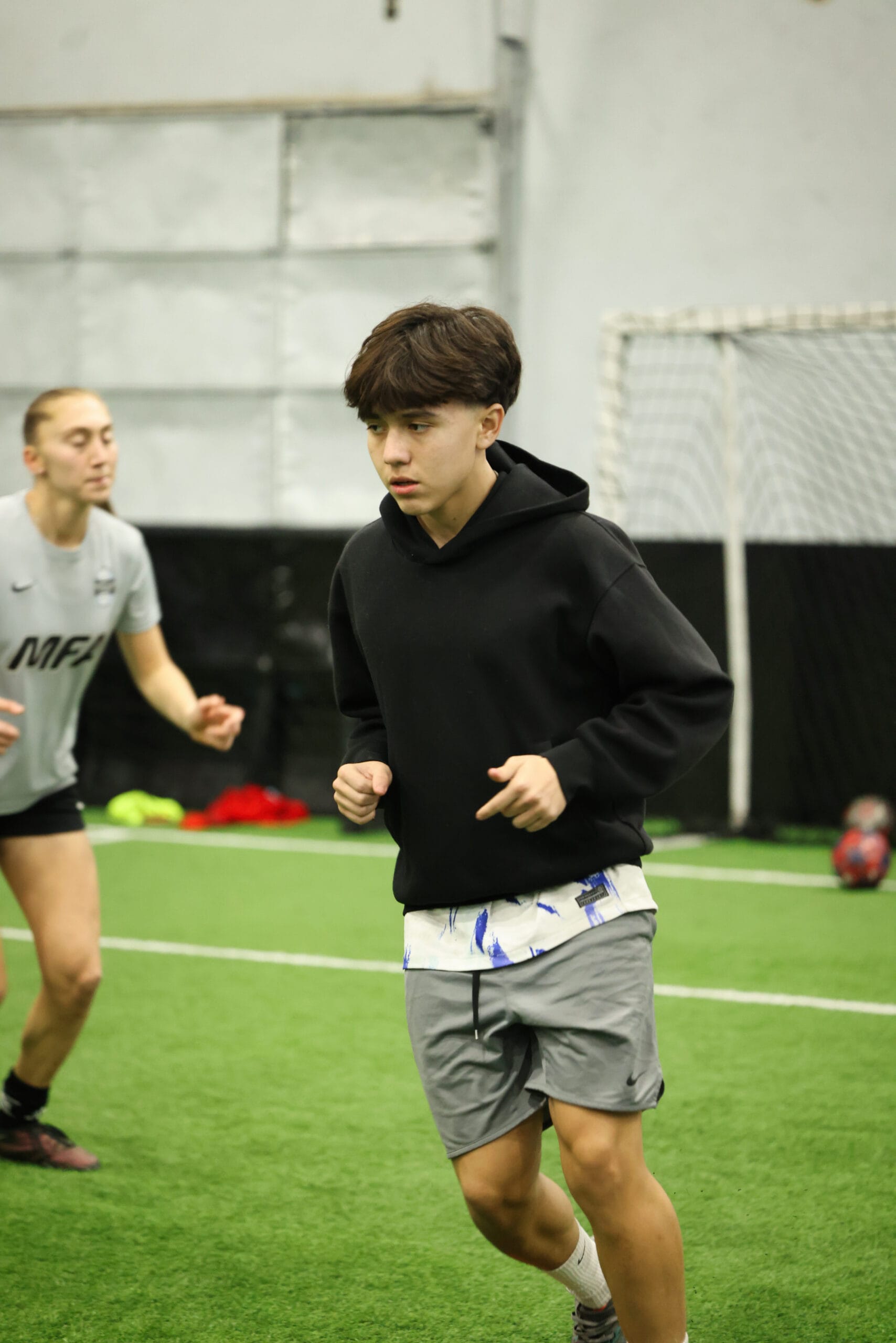 5K2A0312 Teen soccer player developing speed and coordination during high-intensity indoor training session at Pro Soccer Academy
