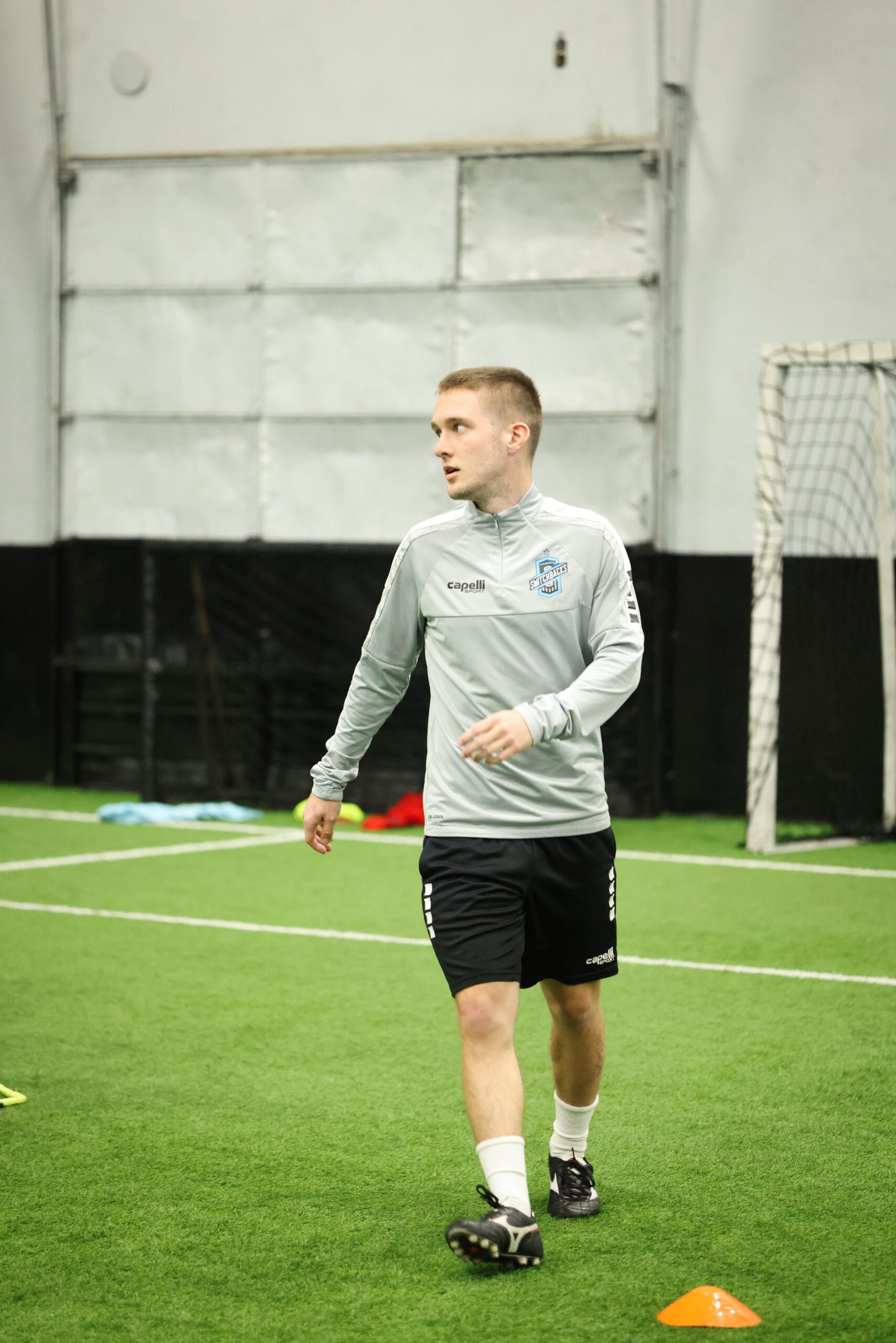 5K2A0317 Soccer coach leading professional indoor training drill focused on technique, spacing, and player development at Pro Soccer Academy