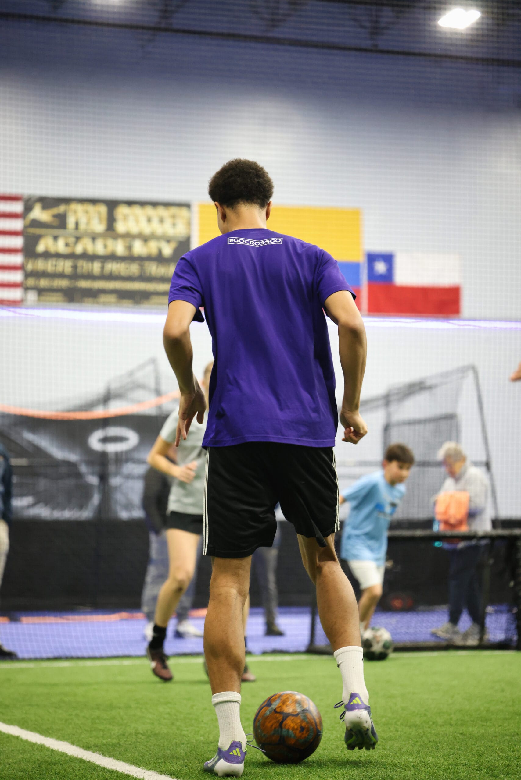 5K2A0404 Youth soccer player controlling the ball during indoor small-group training session at Pro Soccer Academy
