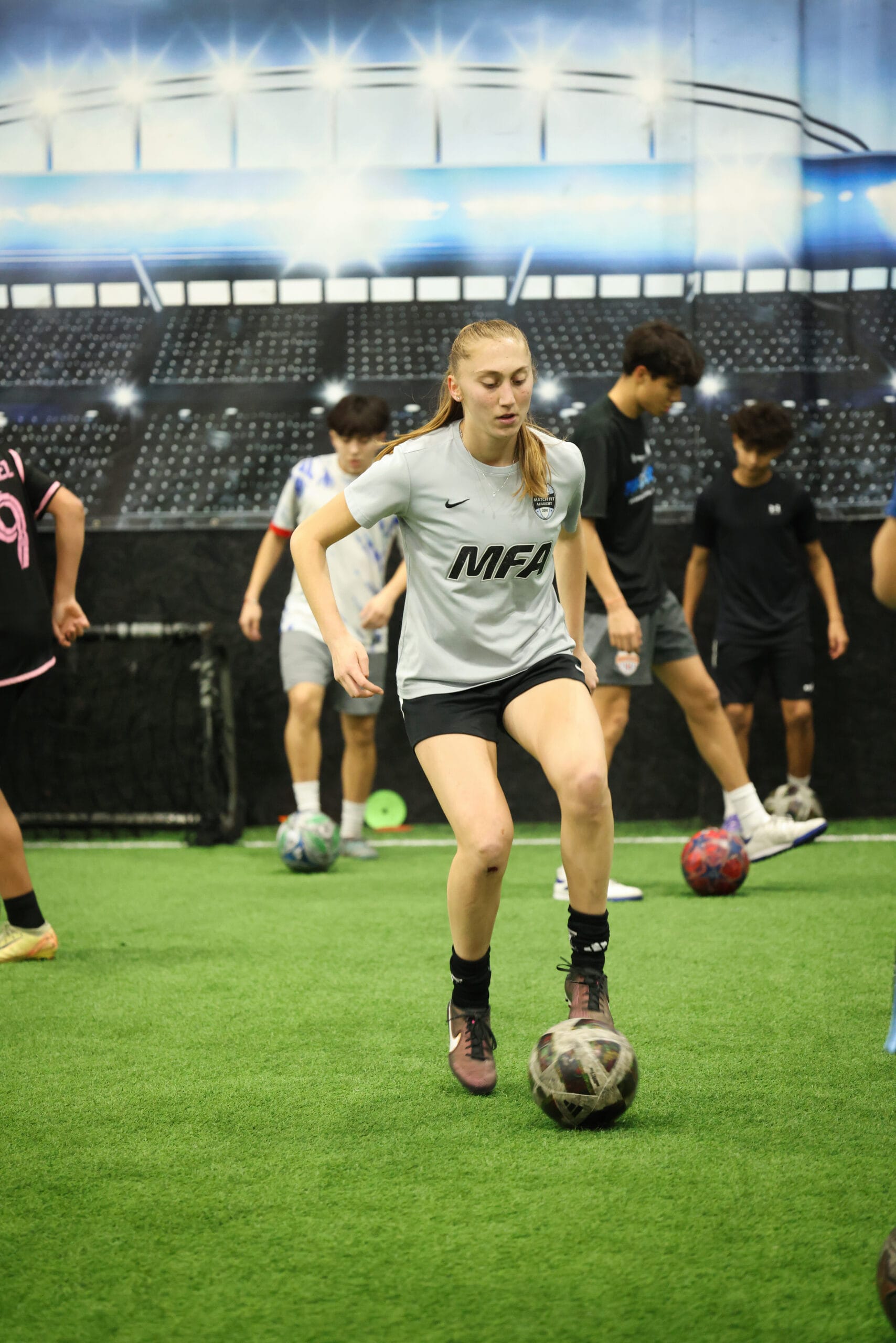 5K2A0419 Female youth soccer player controlling the ball during indoor technical training session at Pro Soccer Academy