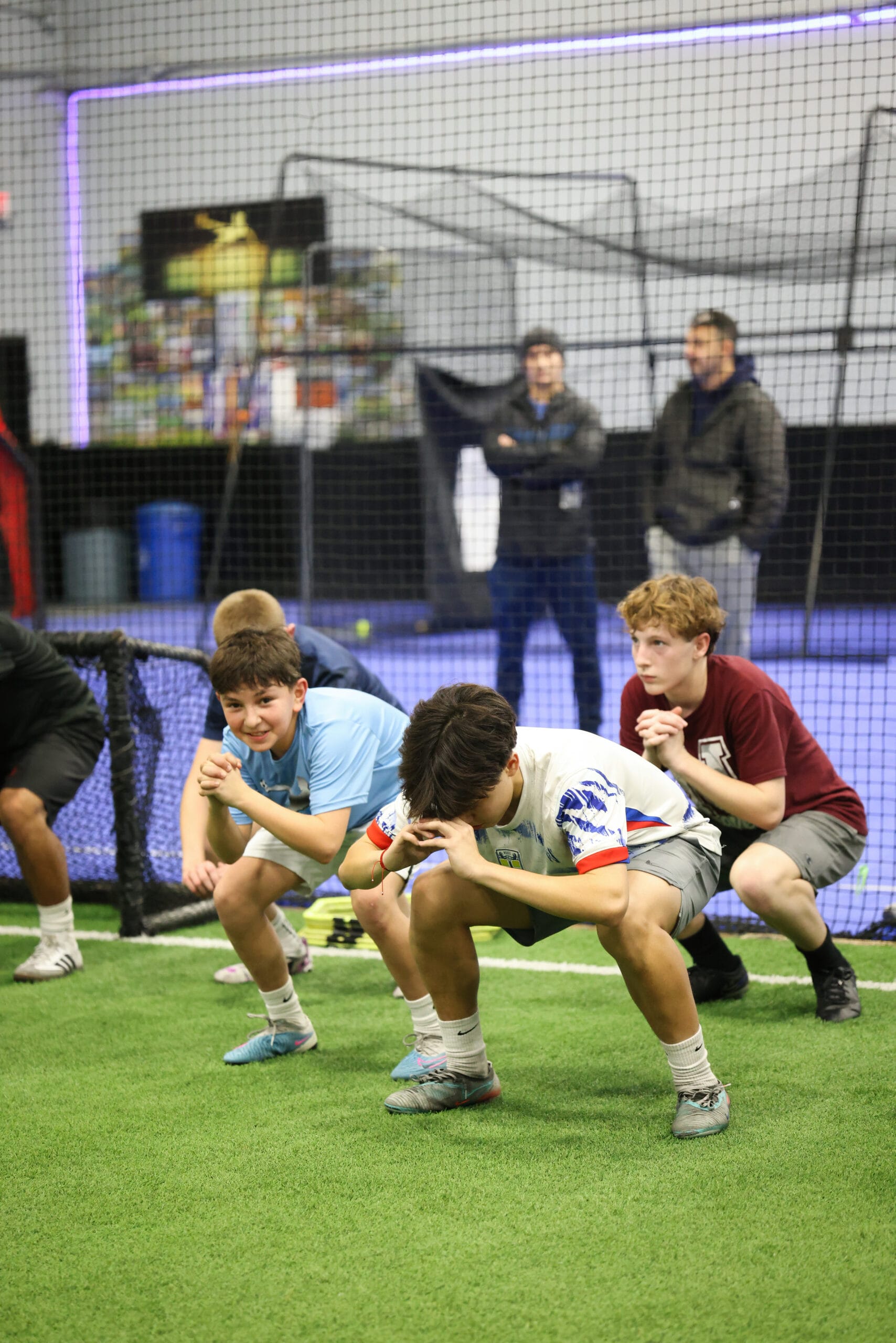 5K2A0511 Youth soccer players performing a strength and balance exercise during indoor soccer training in New Jersey