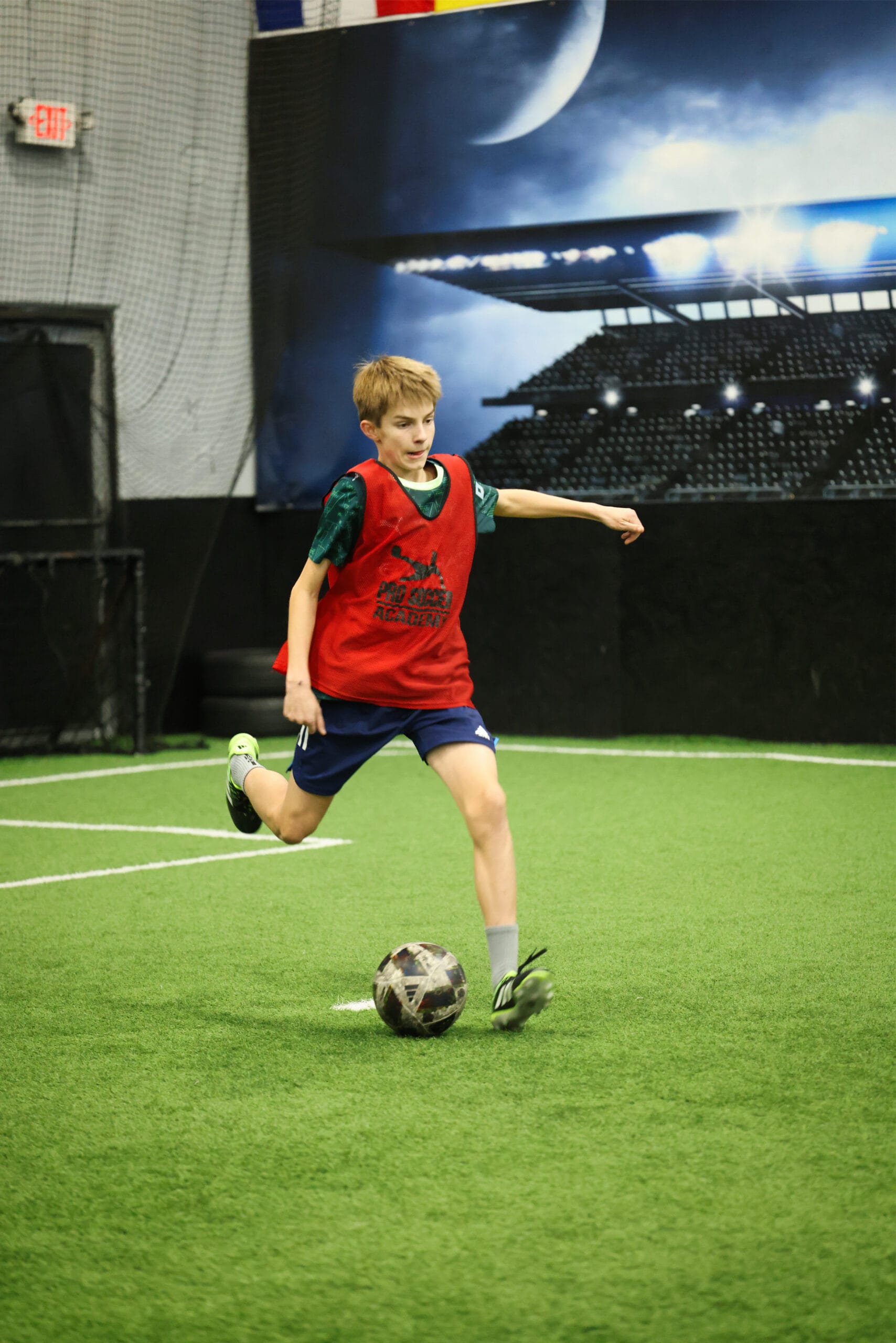 5K2A0645 Youth soccer player striking the ball during an indoor soccer training session in New Jersey