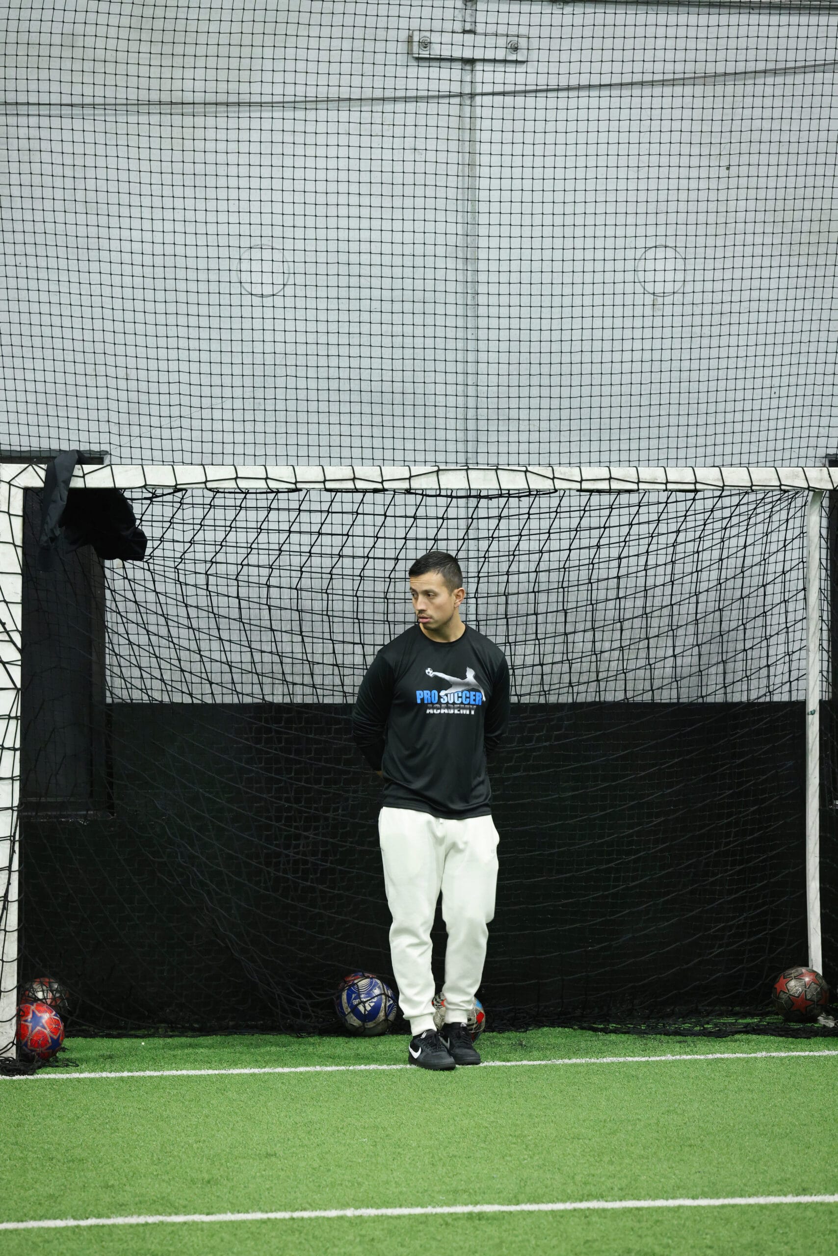 5K2A8681 Coach Dan standing in front of the goal during an indoor soccer training session in New Jersey
