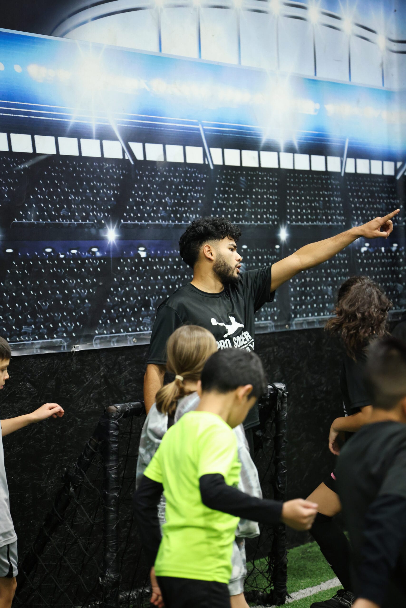 5K2A8697 Coach Kevin giving instructions to youth soccer players during an indoor soccer training session in New Jersey