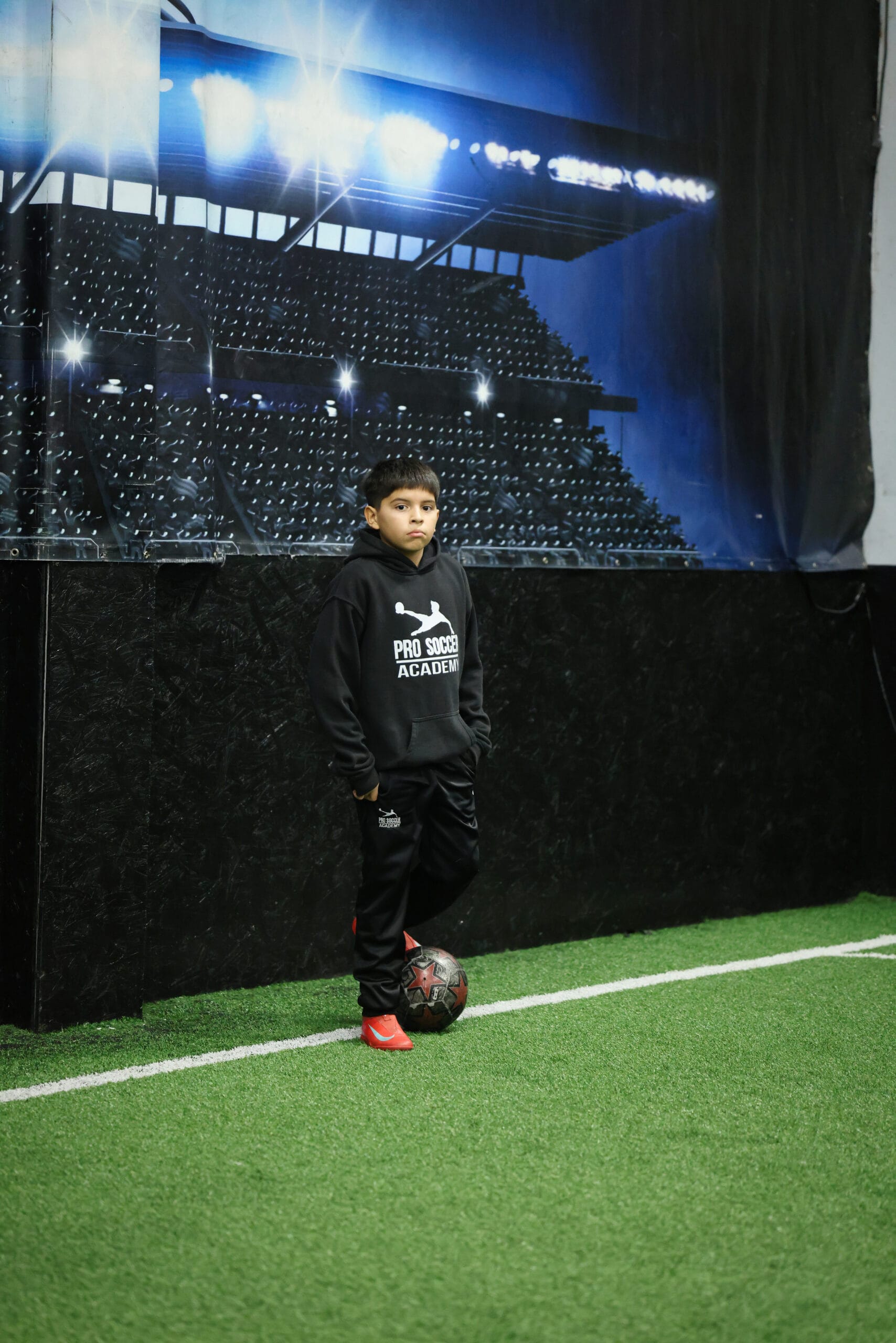 5K2A8699 Young soccer player standing with the ball during an indoor youth soccer training session in New Jersey