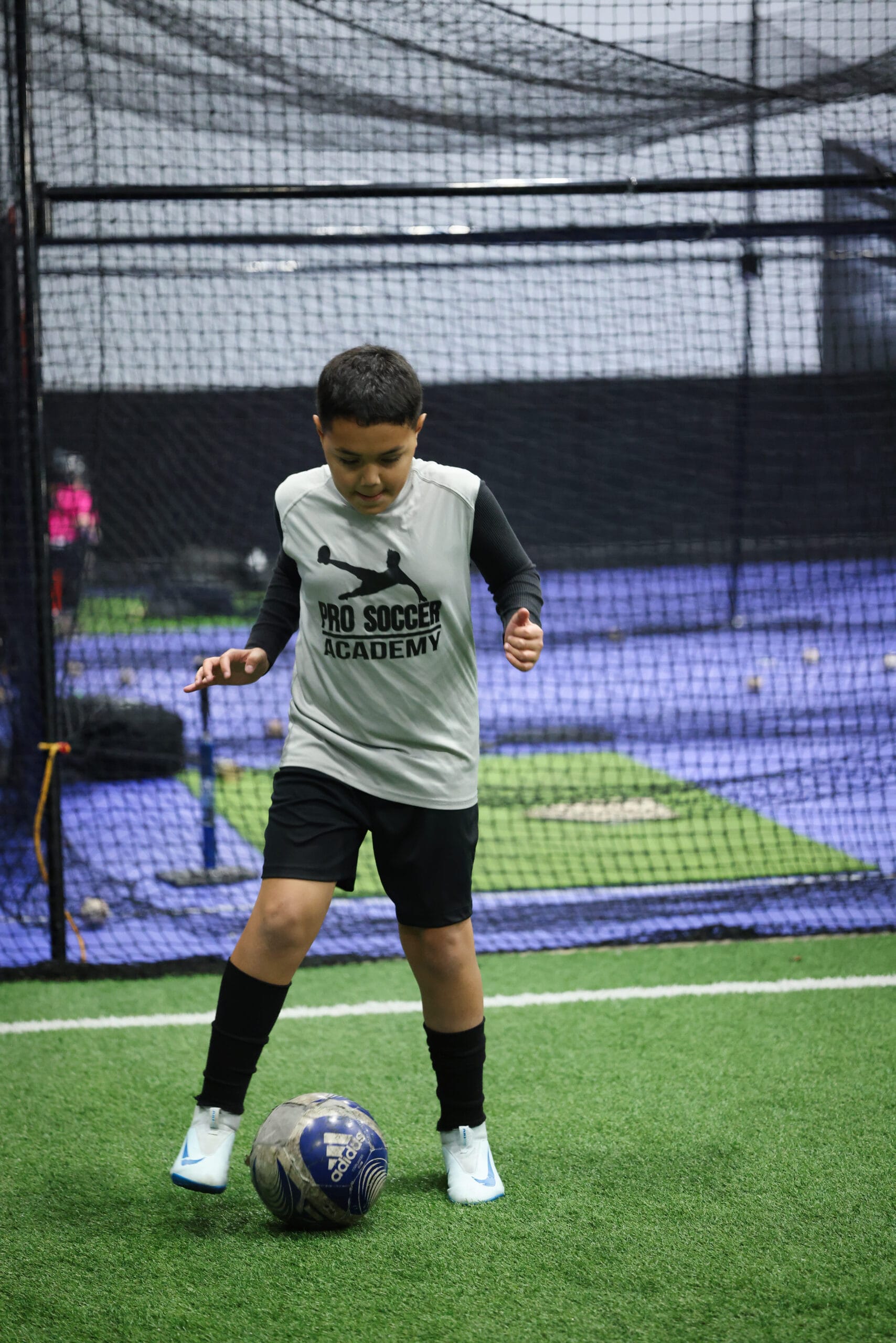 5K2A8714 Youth soccer player working on close ball control during indoor soccer training