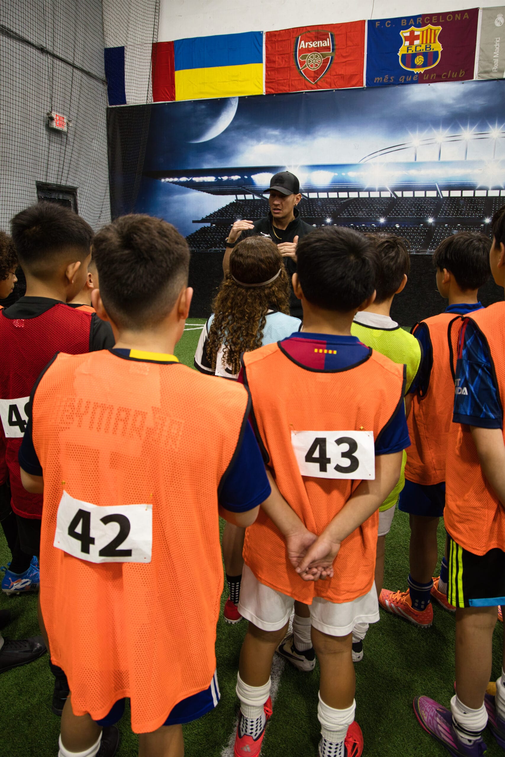 4Q8A0097 Pro Soccer Academy youth soccer players listening to coach during indoor training session