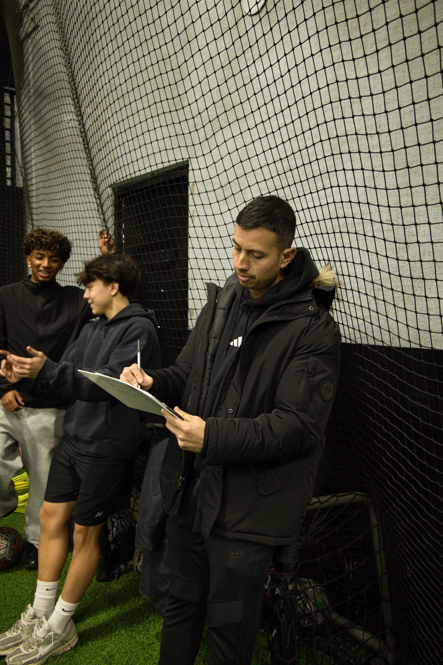 4Q8A0143 Pro Soccer Academy coach taking notes during youth soccer evaluations