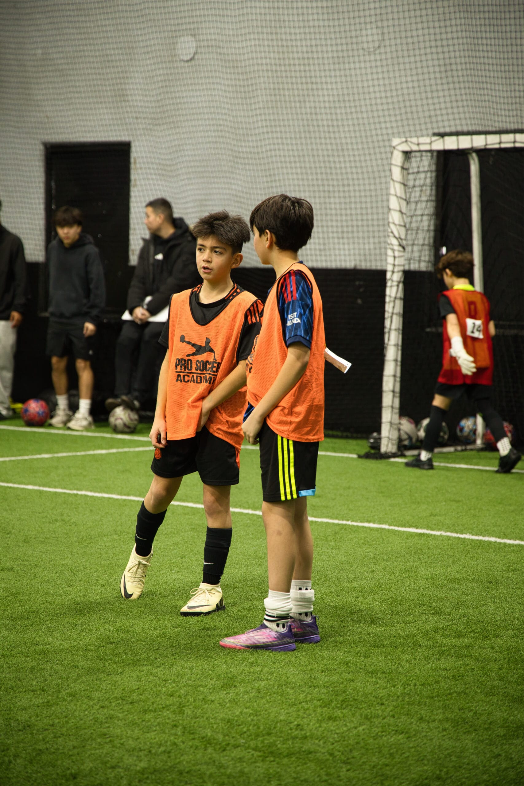 4Q8A0151 Youth soccer players communicating on indoor turf field at Pro Soccer Academy