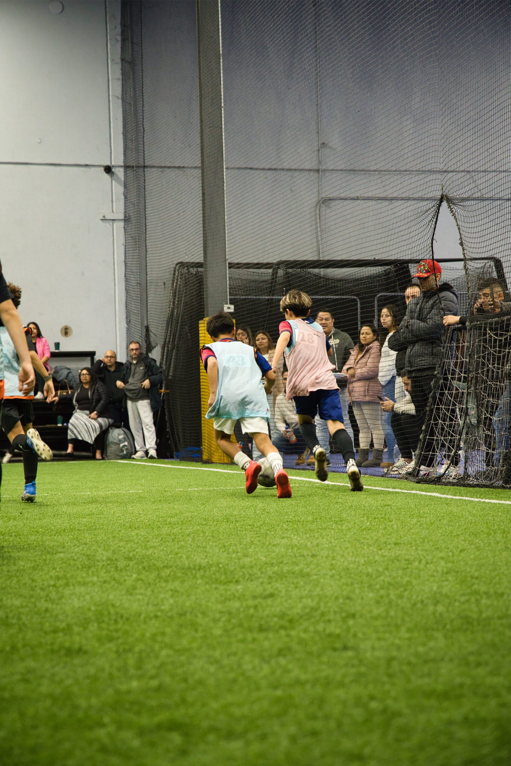 4Q8A0185 Two youth soccer players competing for the ball in front of goal at Pro Soccer Academy