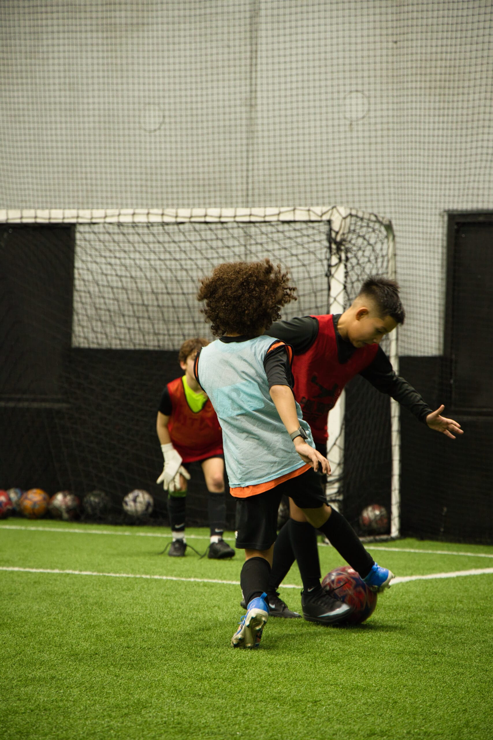 4Q8A0200 Two youth players challenging for the ball in front of goal during Pro Soccer Academy scrimmage