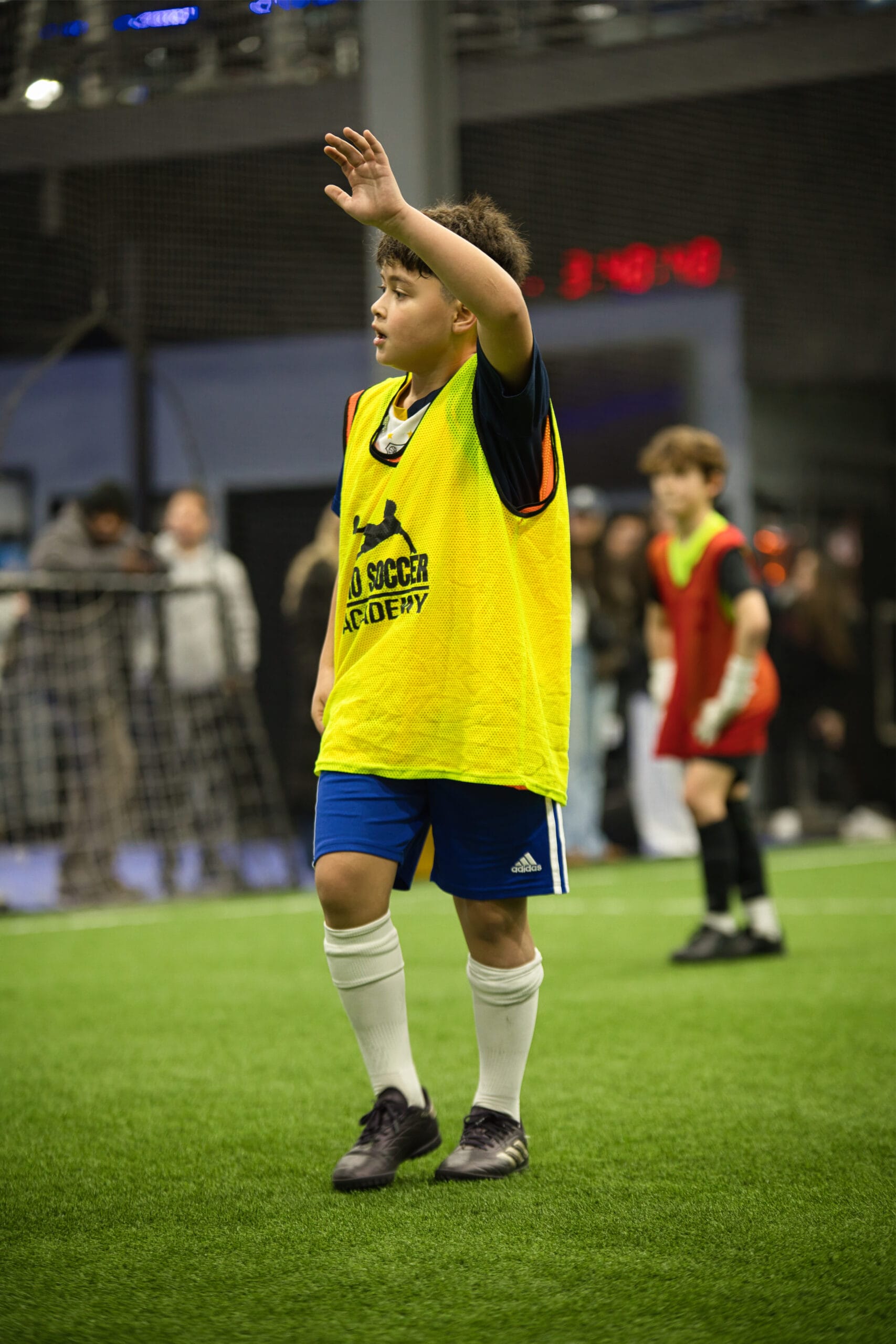 4Q8A0328 Youth soccer player raising hand to call for the ball during indoor Pro Soccer Academy scrimmage.