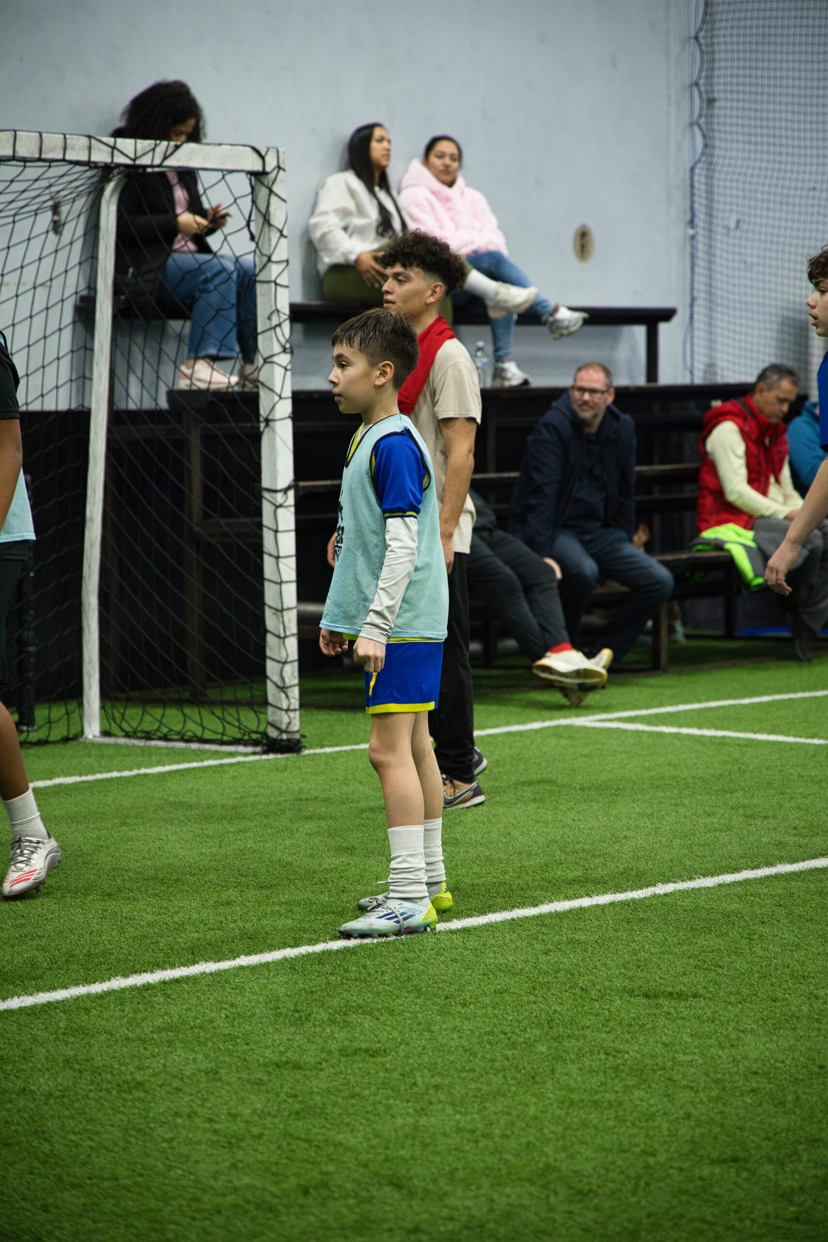 4Q8A0318 Youth soccer player at Pro Soccer Academy showing high focus while waiting to receive the ball during an indoor training session.