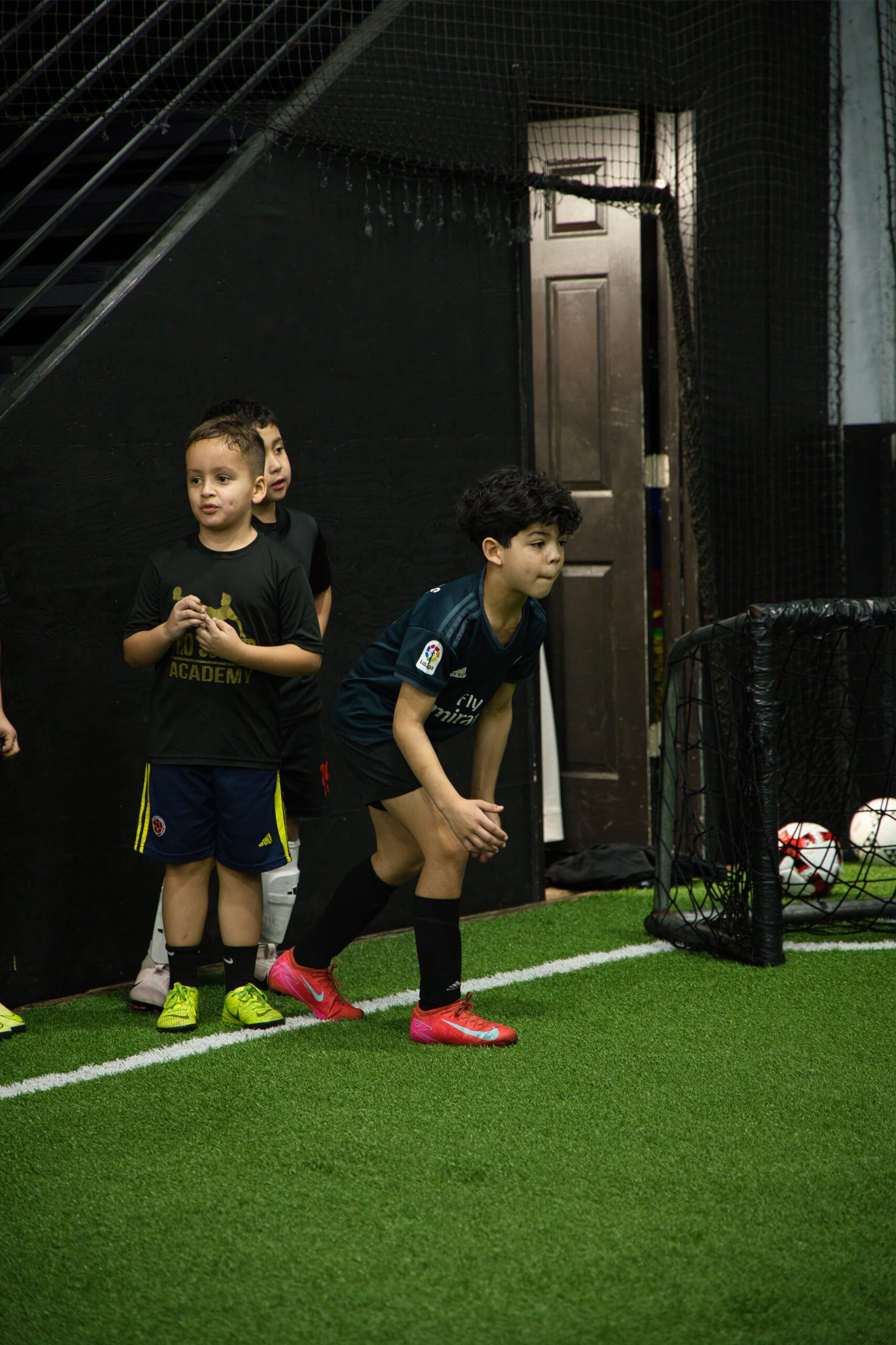 4Q8A0332 Youth soccer players preparing for a drill during Pro Soccer Academy indoor training.
