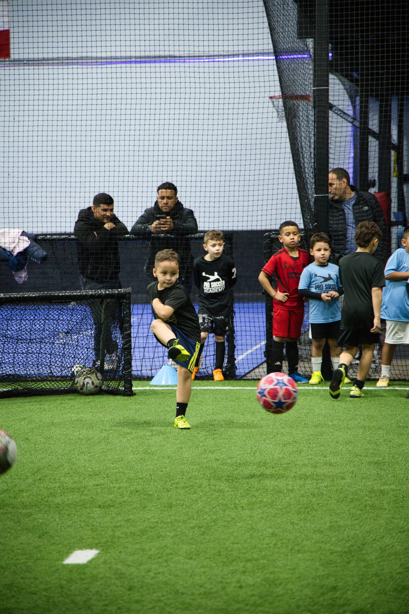 4Q8A0351 Young soccer player shooting the ball during a Pro Soccer Academy finishing drill.