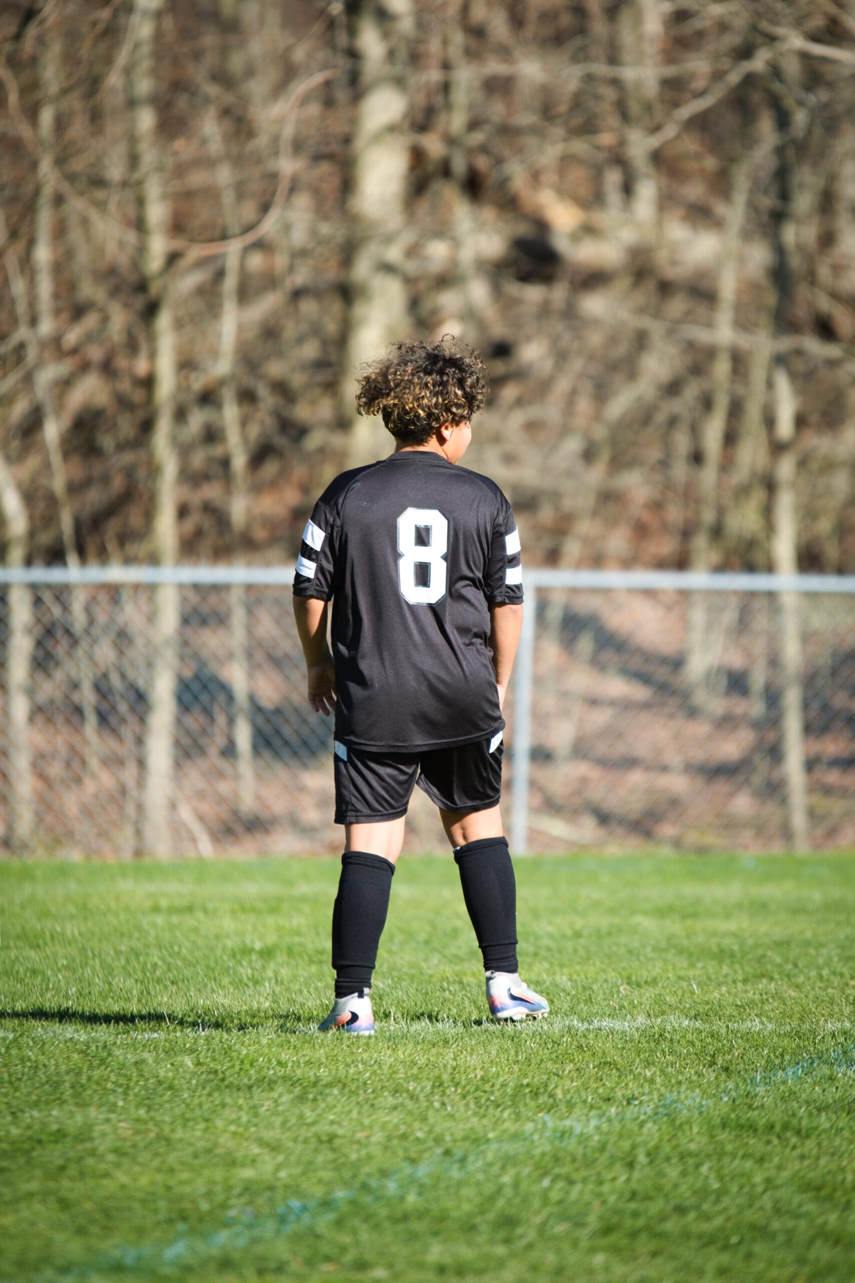 Youth goalkeeper practicing ball control during indoor soccer training session at Pro Soccer Academy facility