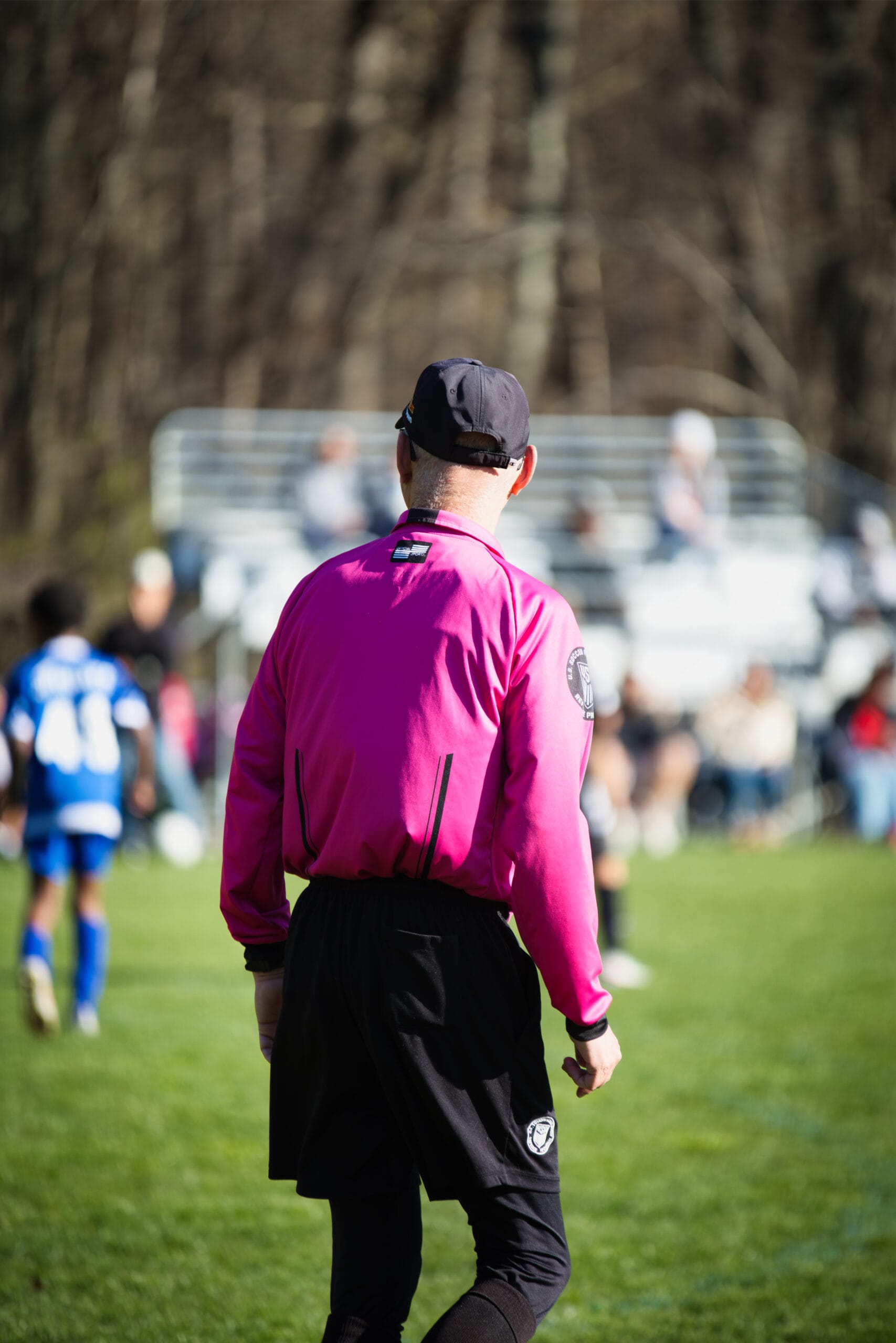Soccer coach standing on indoor field at Pro Soccer Academy overseeing youth training session